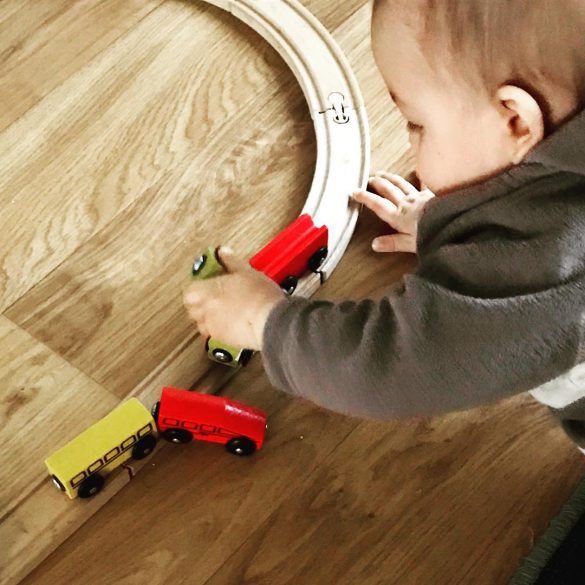 child playing with train set