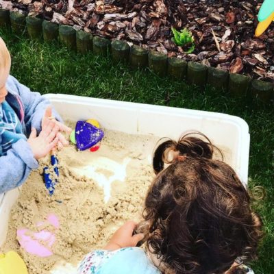 Children playing with sand outdoors